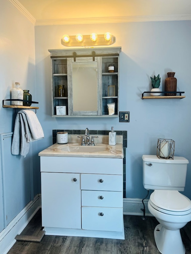 bathroom featuring crown molding, vanity, toilet, and wood-type flooring