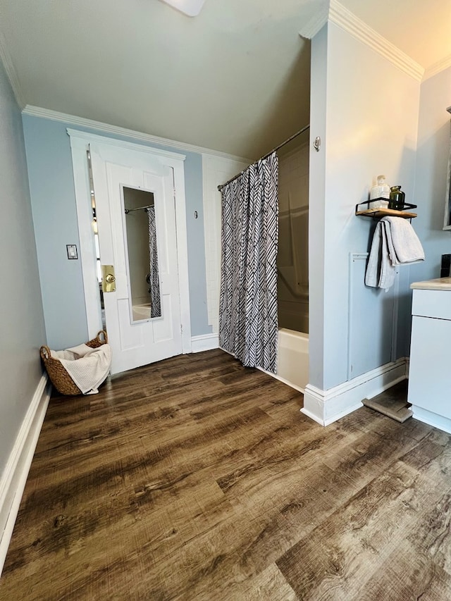 bathroom with shower / tub combo, ornamental molding, and hardwood / wood-style floors