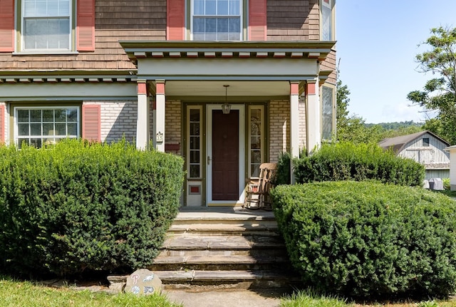 view of exterior entry with covered porch