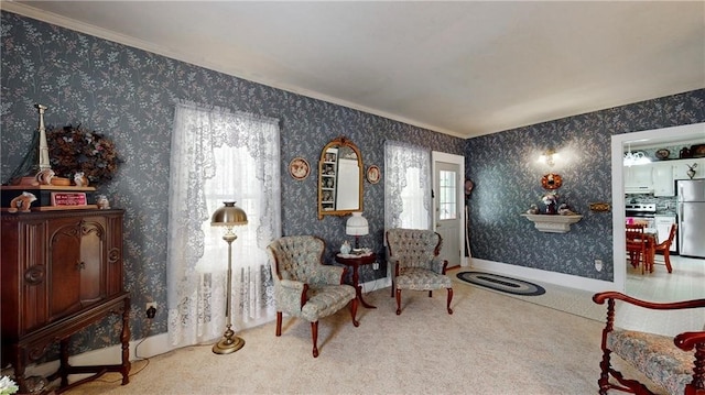 sitting room featuring crown molding and carpet flooring