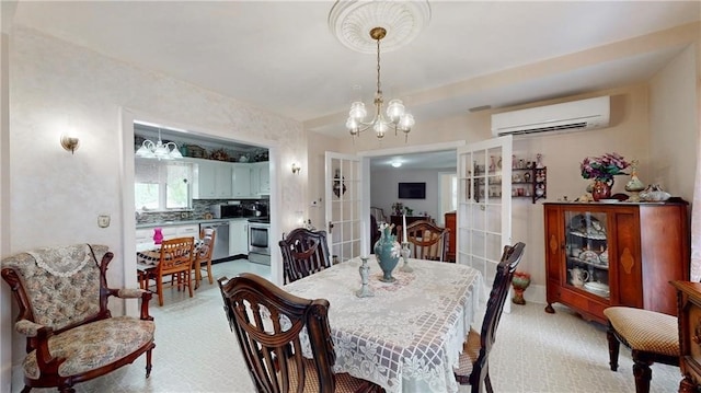 dining room featuring french doors, a wall mounted air conditioner, and a notable chandelier