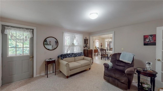 living room featuring carpet and an inviting chandelier