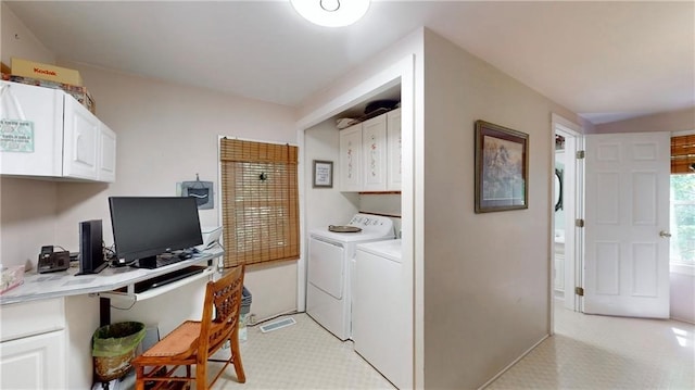 washroom featuring washer and dryer and cabinets