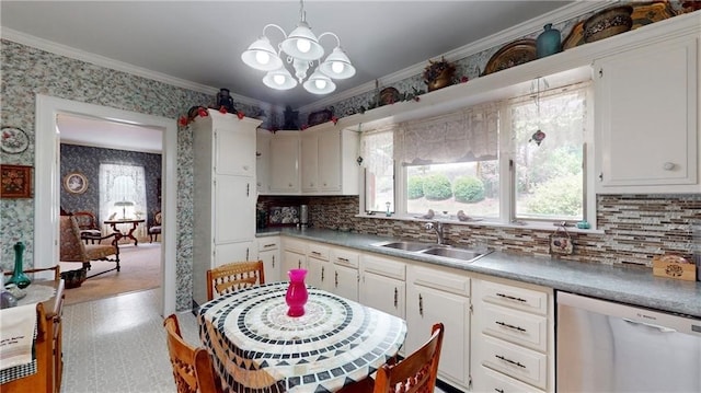 kitchen featuring ornamental molding, sink, stainless steel dishwasher, decorative light fixtures, and white cabinetry