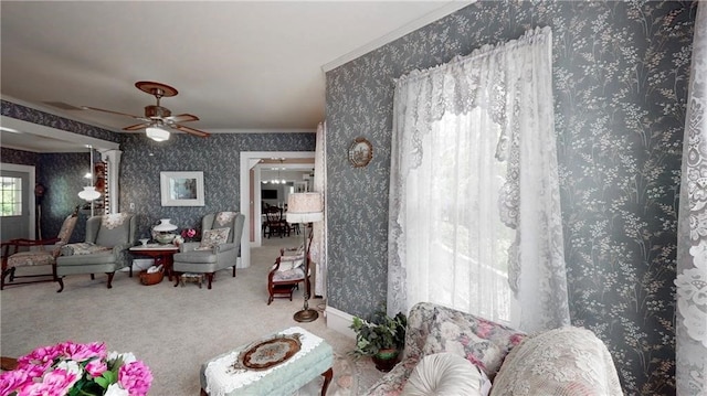 living room with ceiling fan, carpet floors, decorative columns, and ornamental molding