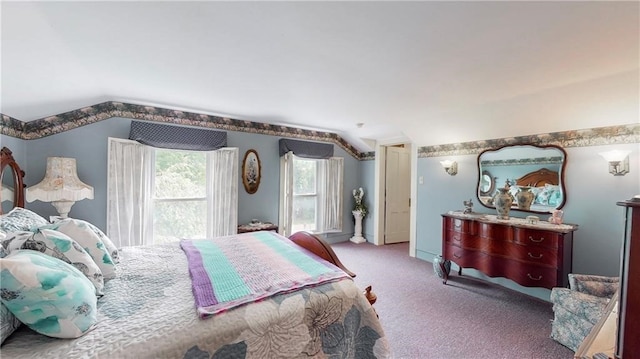 carpeted bedroom with lofted ceiling