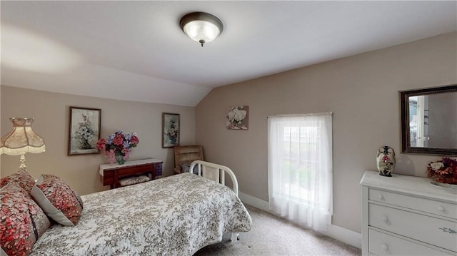 carpeted bedroom with lofted ceiling