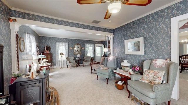 living area with ornamental molding, ceiling fan, ornate columns, and carpet flooring