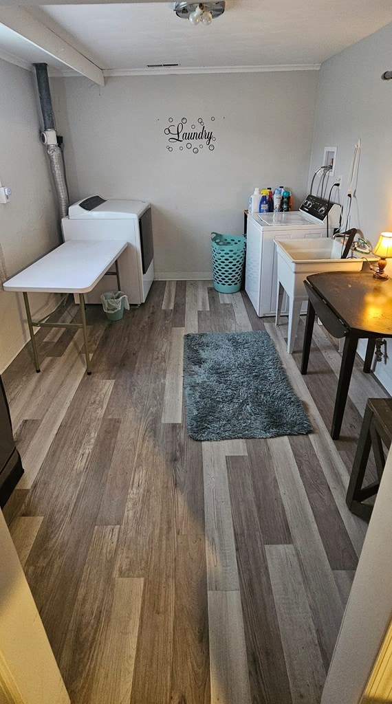 washroom with hardwood / wood-style floors and washer and dryer