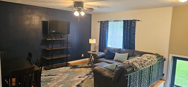 living room featuring ceiling fan and hardwood / wood-style flooring