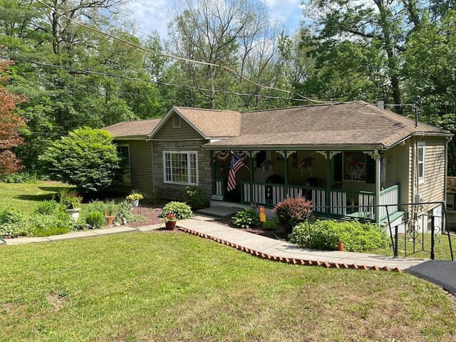 view of front of home with covered porch and a front yard