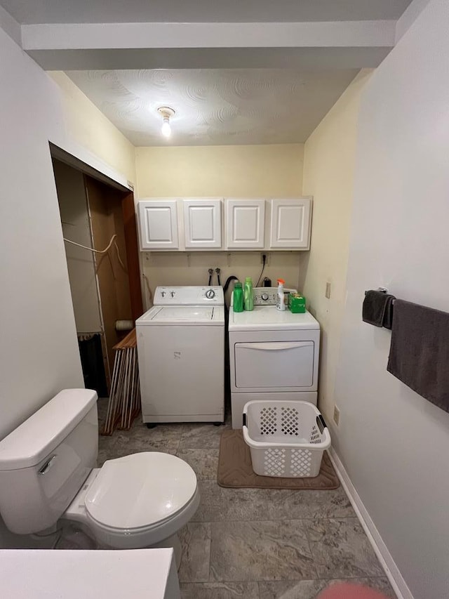 bathroom featuring washing machine and clothes dryer