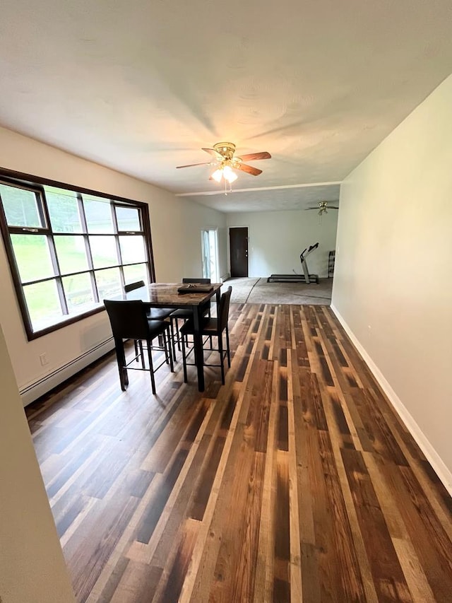 dining room with baseboard heating, ceiling fan, and dark hardwood / wood-style floors