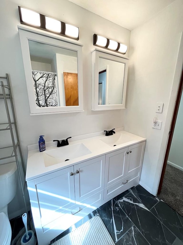 bathroom featuring vanity and toilet