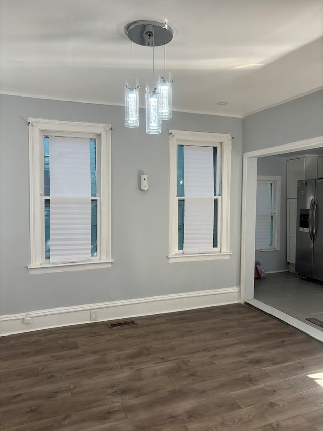 unfurnished dining area with dark wood-type flooring