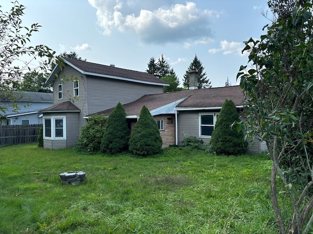 rear view of property with a yard