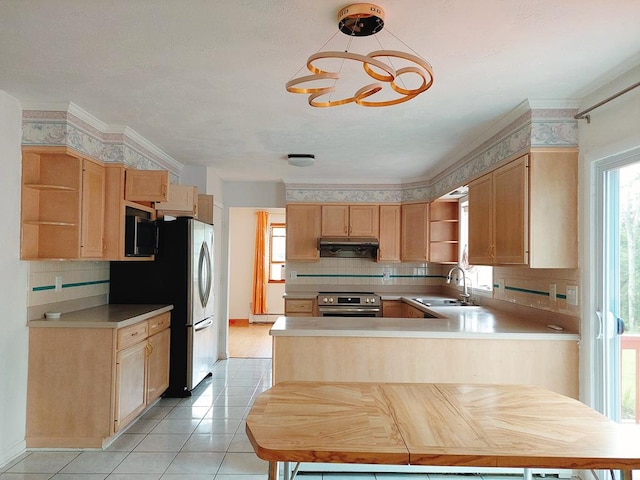 kitchen with kitchen peninsula, sink, hanging light fixtures, and light brown cabinets