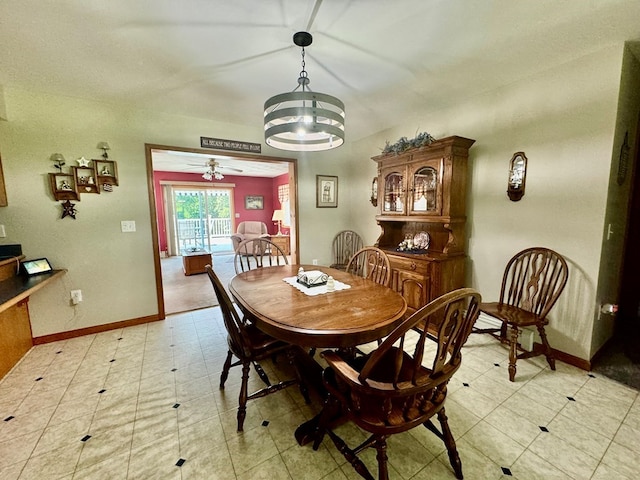 dining space featuring ceiling fan with notable chandelier