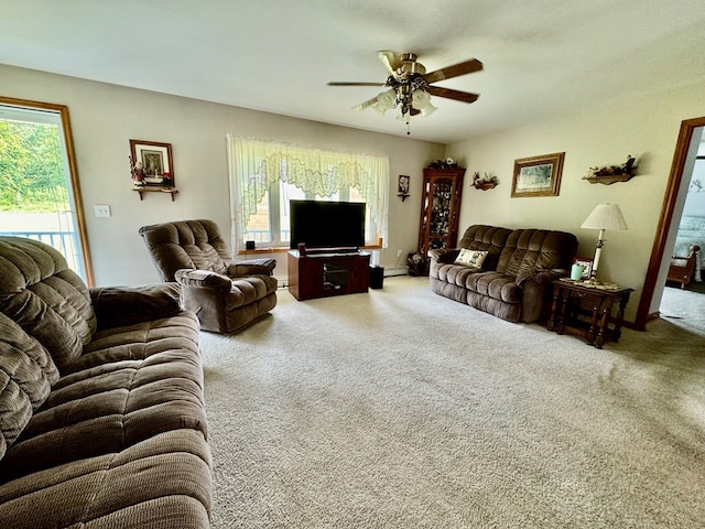 carpeted living room featuring ceiling fan and a baseboard heating unit