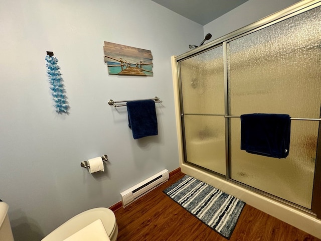 bathroom featuring hardwood / wood-style flooring, toilet, an enclosed shower, and baseboard heating