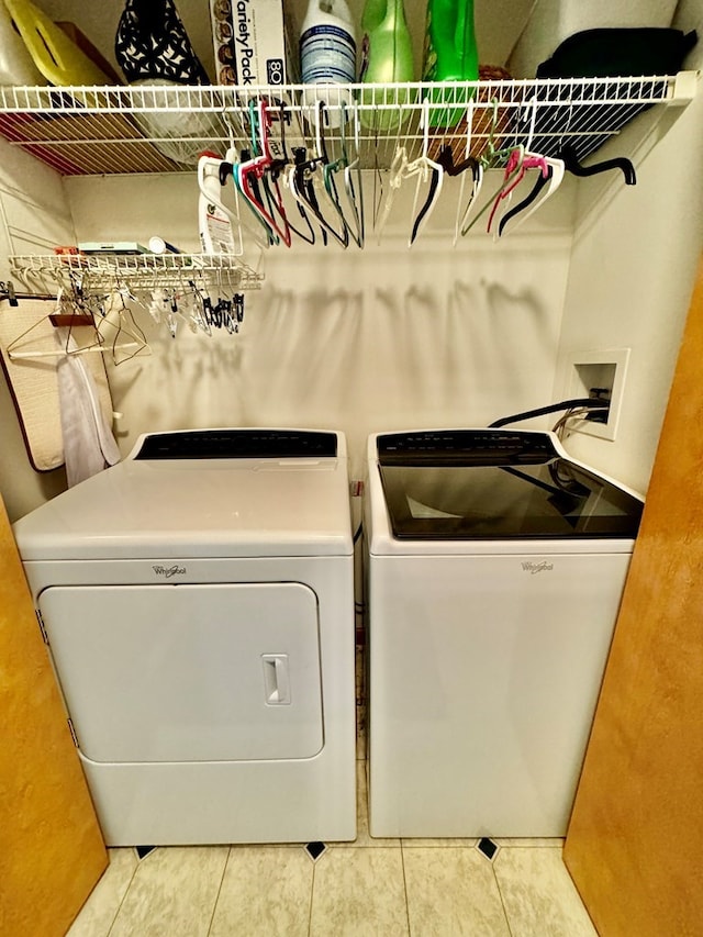 washroom with tile patterned flooring and washer and dryer