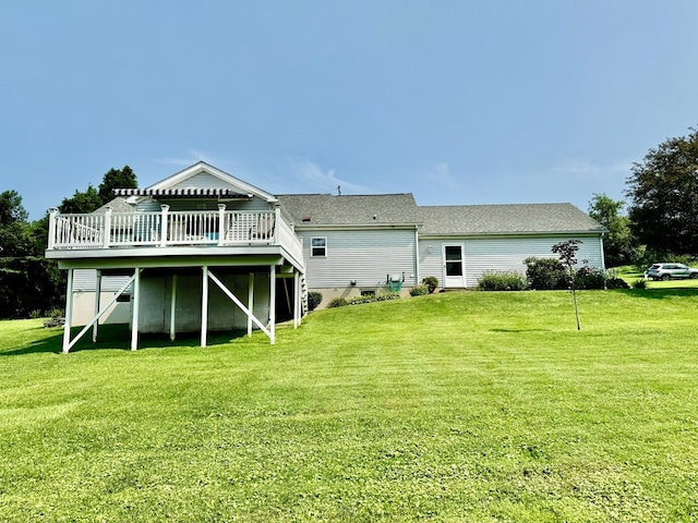 back of house with a lawn and a deck