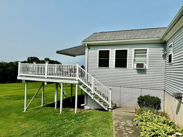 back of house with a deck and a yard