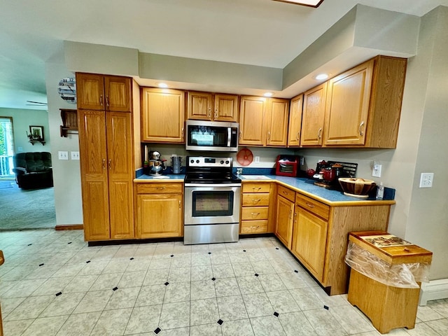 kitchen with light tile patterned floors and stainless steel appliances