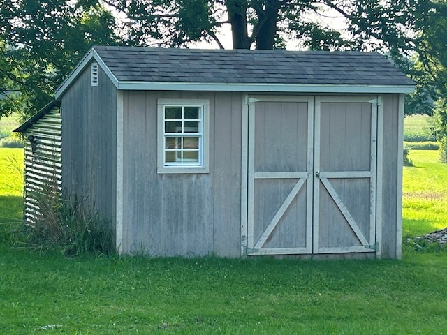 view of outbuilding with a lawn