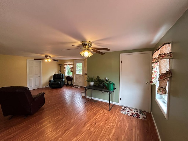 living room featuring hardwood / wood-style flooring and ceiling fan