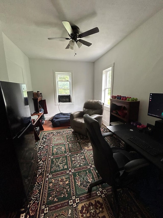 office area with ceiling fan and a textured ceiling