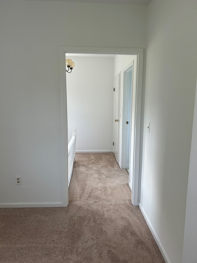 hallway featuring light carpet