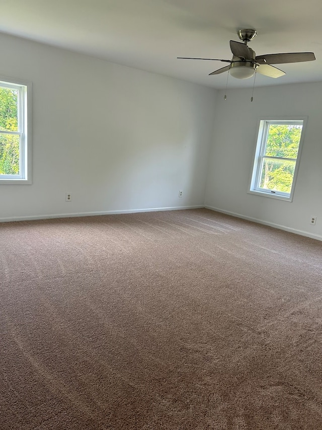 carpeted empty room featuring ceiling fan