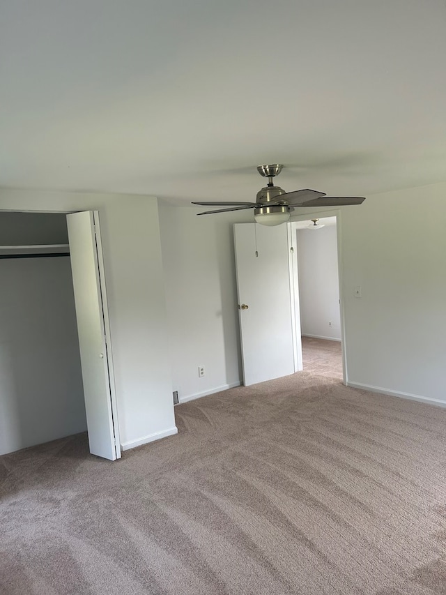 unfurnished bedroom featuring ceiling fan and light colored carpet