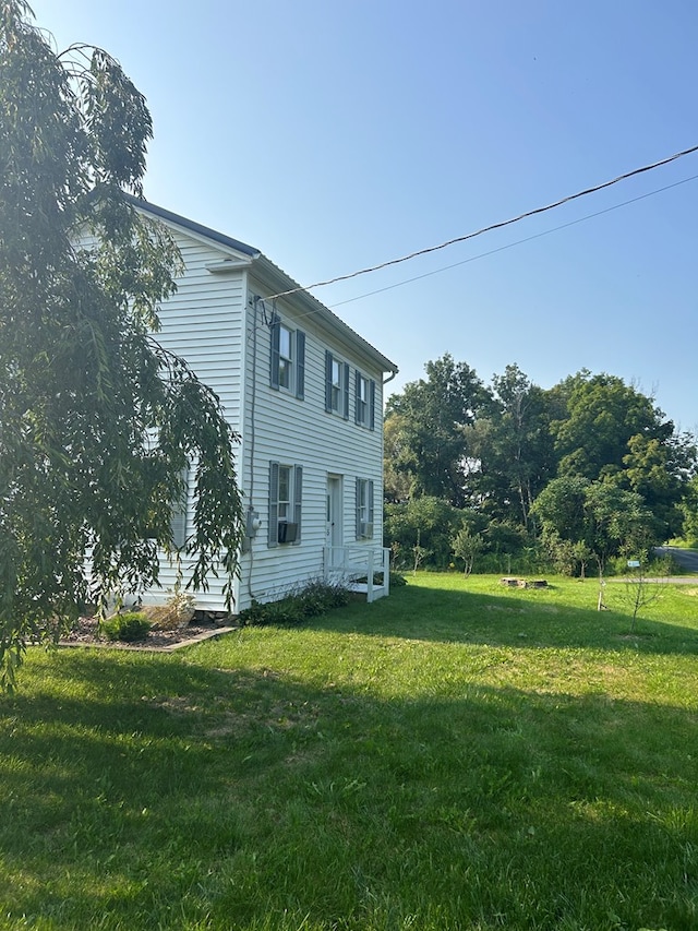 view of home's exterior with a lawn