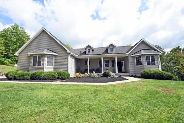 view of front of home featuring a front yard and covered porch