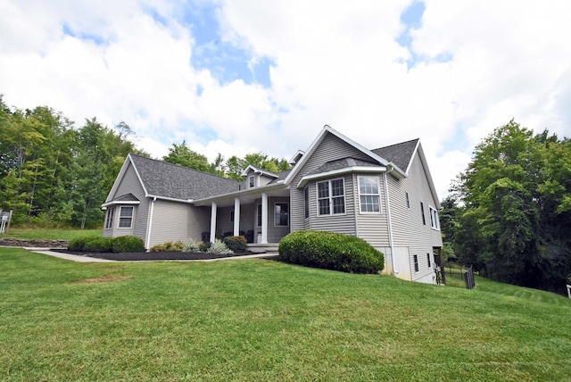 view of front of home featuring covered porch and a front lawn