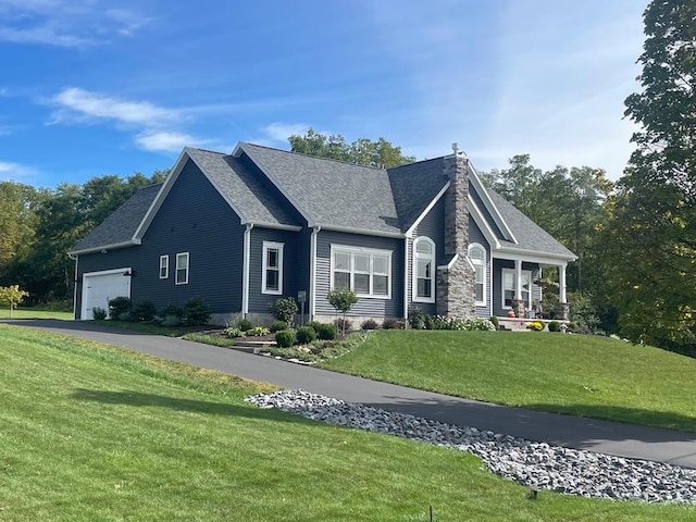 view of front of home with a front lawn and a garage