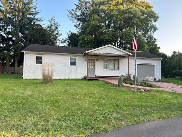 ranch-style home with a garage and a front lawn