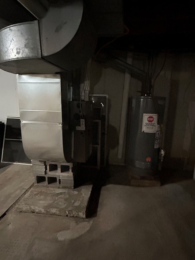 utility room featuring water heater