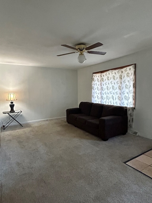 carpeted living room with ceiling fan