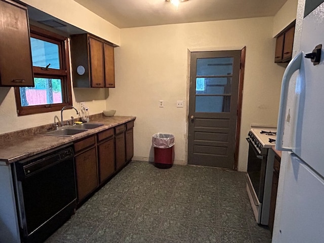 kitchen featuring dark brown cabinets, sink, and white appliances