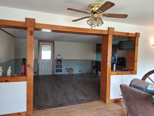 living room with ceiling fan and light hardwood / wood-style flooring