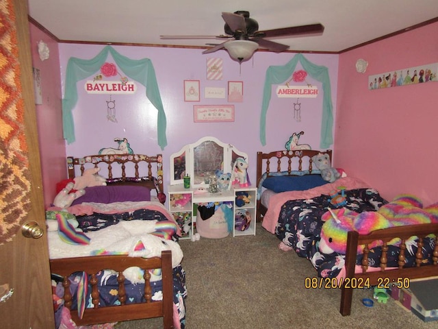 carpeted bedroom featuring crown molding and ceiling fan