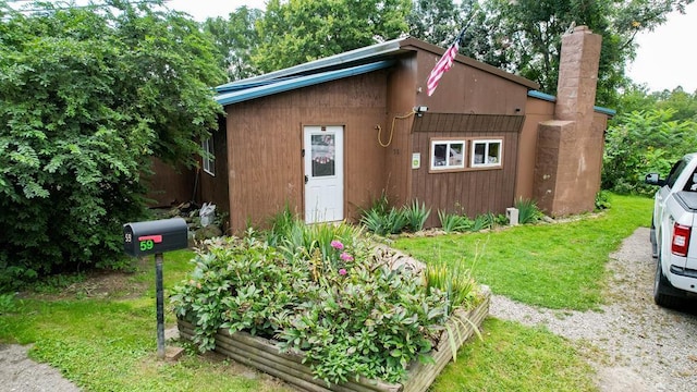 view of outbuilding featuring a lawn