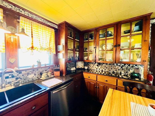 kitchen featuring dishwasher, backsplash, and sink