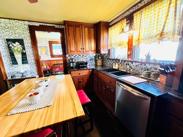 kitchen with dishwasher, tasteful backsplash, and sink