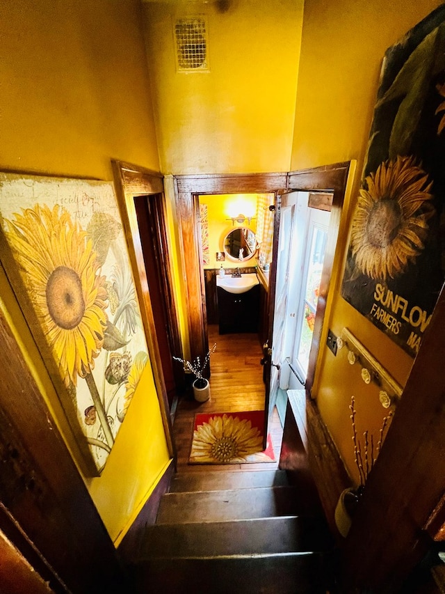 hallway featuring sink and hardwood / wood-style floors