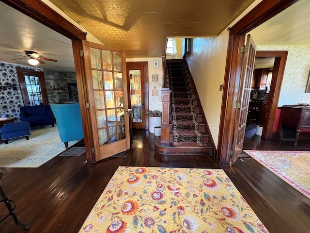 staircase with ceiling fan, french doors, and dark hardwood / wood-style flooring