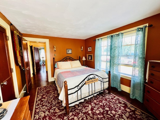 bedroom with dark wood-type flooring